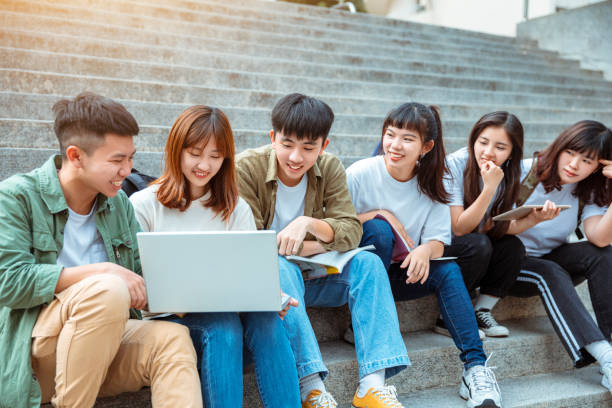 istock Group of students studying on the stairs  at campus 1204084589