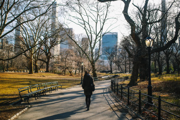 istock Young woman walking in the NYC Central park 1204084811