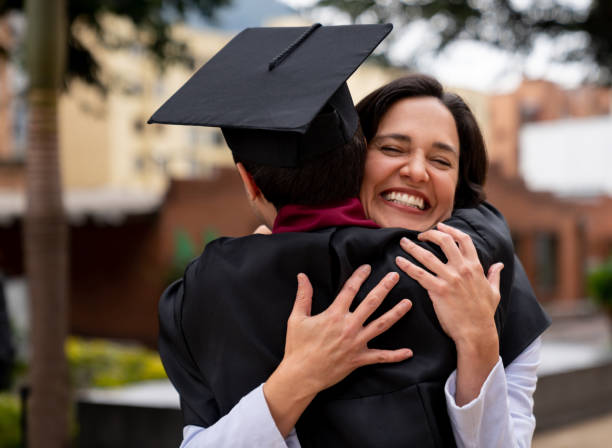 istock Proud mother hugging her graduating son 1204089290