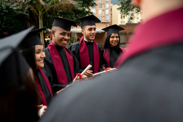 istock Multi-ethnic group of students graduating and looking happy 1204089354