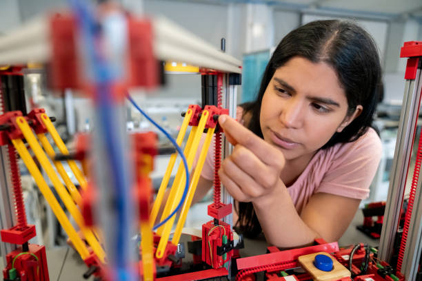 istock Female engineer at the lab building a robot 1204089358