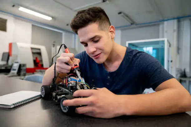 Photo of Student in an engineering class working on a robot project