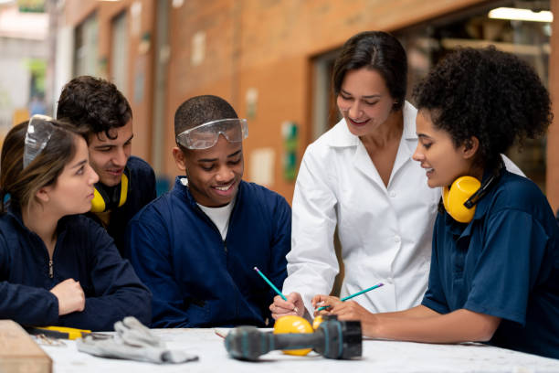istock Teacher talking to a group of industrial design students about a project 1204089438
