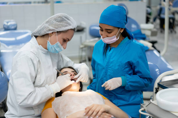 Teacher and student at dental school examining a patient
