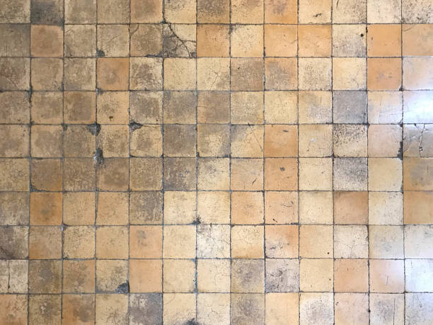 istock Ancient vintage cracked square brown tile floor or wall for background and texture 1204090399