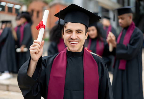 istock Happy graduate student holding his diploma 1204093177
