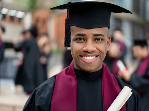 istock Happy graduating student holding his diploma 1204093186