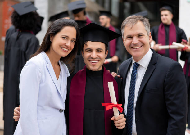 istock Happy graduating student smiling with his parents 1204093203