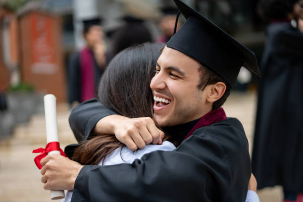 istock Happy student hugging his mother on graduation day 1204093224
