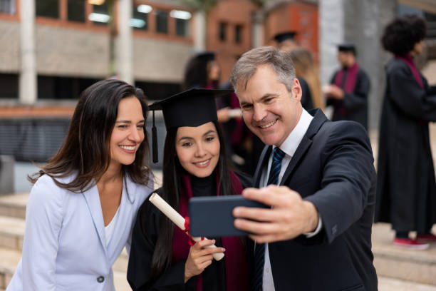 istock Proud parents taking a picture with their graduating daughter 1204093230