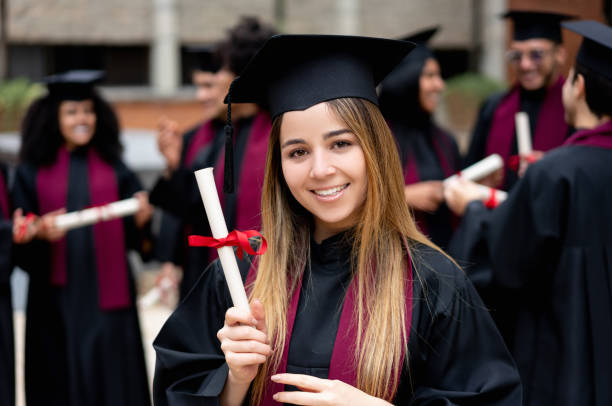 istock Happy graduation student holding her diploma 1204093253