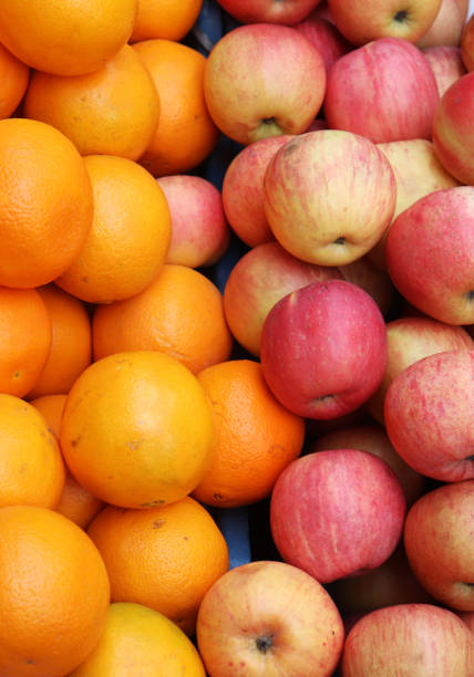 istock Fresh red apples and orange in the shop 1204096008