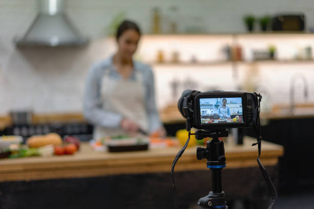 istock Vegetarian woman recording a cooking tutorial at home 1204096352