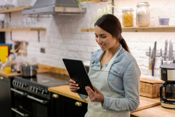 istock Woman at home taking cooking lessons online 1204096874
