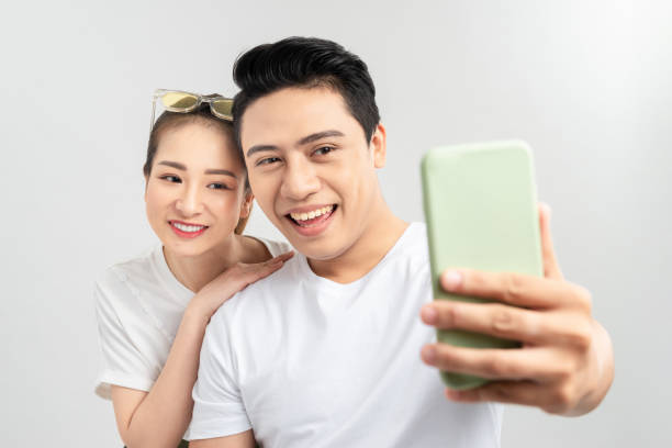 istock Beautiful young couple making selfie on smartphone 1204097563