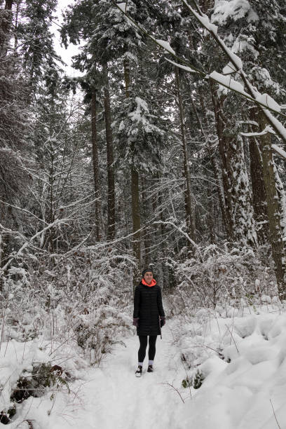 istock Young Women Standing On A Snowy Pathway 1204097827