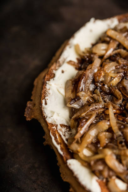Homemade pizza with goat cheese, caramelized onion and balsamic vinegar. Selective focus. Shallow depth of field.