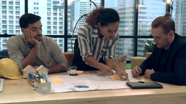 istock Creative business people group having conversation at office desk in workplace. 1204102904