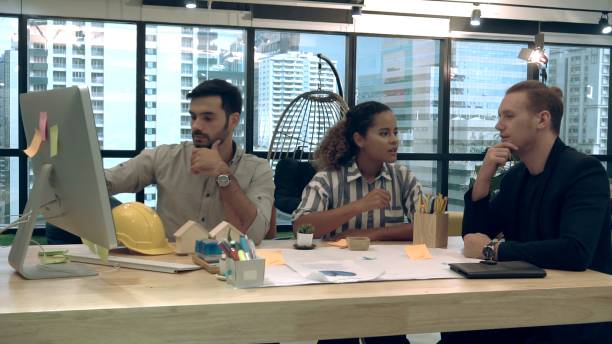 istock Creative business people group having conversation at office desk in workplace. 1204102910