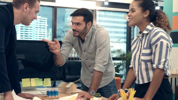 istock Creative business people group having conversation at office desk in workplace. 1204102944
