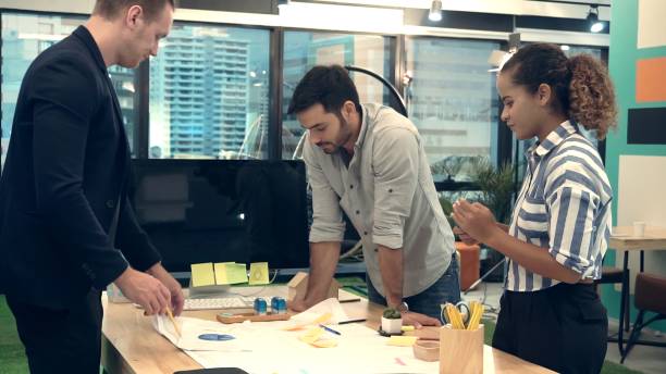 istock Creative business people group having conversation at office desk in workplace. 1204102948