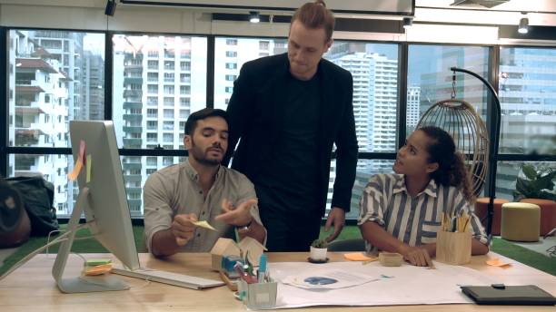 istock Creative business people group having conversation at office desk in workplace. 1204102966