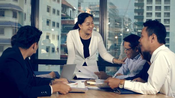 istock Asian business people discuss marketing strategy. 1204103740