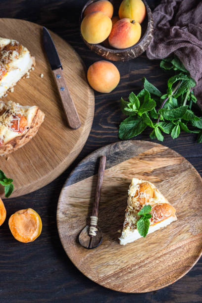 istock Cheesecake with apricot and crumble, fresh apricots and mint. Rustic style. 1204107629