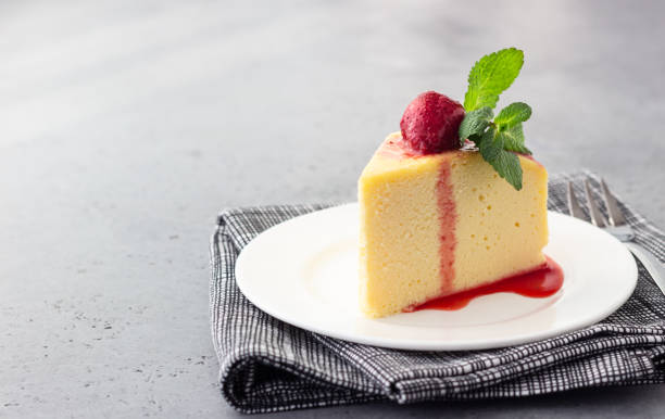 a piece of japanese cotton cheesecake with mint and strawberry. selective focus, copy space. - smooth part of colors yellow imagens e fotografias de stock