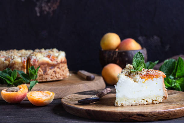 istock Cheesecake with apricot and crumble, fresh apricots and mint. Rustic style. 1204108467