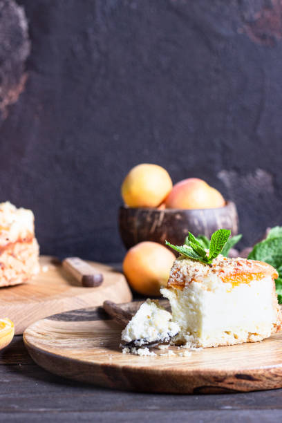 istock Cheesecake with apricot and crumble, fresh apricots and mint. Rustic style. 1204108476