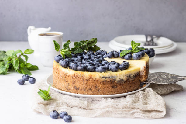istock New York style cheesecake, blueberries and mint on a white plate. 1204108572