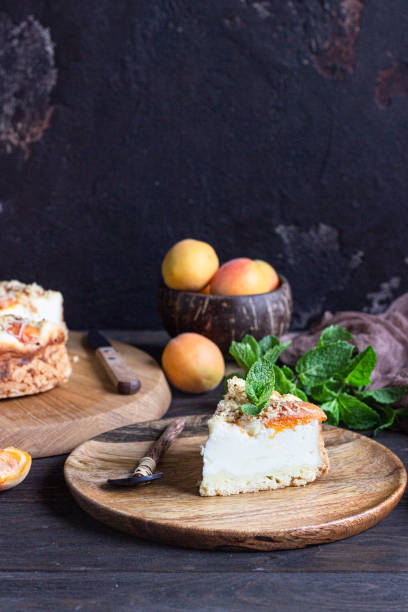 istock Cheesecake with apricot and crumble, fresh apricots and mint. Rustic style. 1204108647