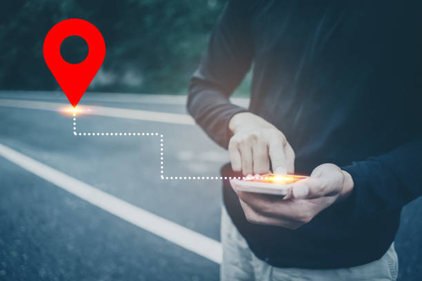 istock Man hand using smartphone with gps navigator map icon on blur street background. 1204109069