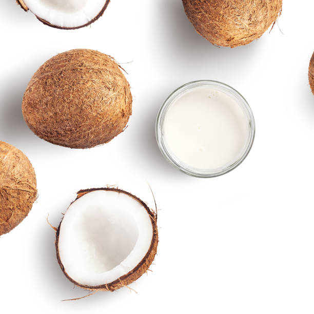 Creative layout made of coconut and coconut milk on white background Creative layout made of coconut and coconut milk on white background. Flat lay. Food concept. Macro concept. coconut milk photos stock pictures, royalty-free photos & images