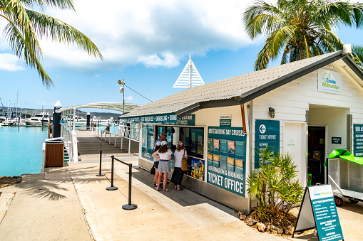 Tourists are purchasing ticket at Cruise Whitsundays ticket office in Hamilton Island, Australia.