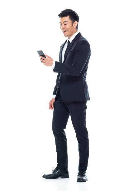 istock East asian ethnicity young male manager standing and using smart phone 1204112342