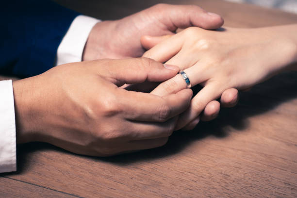 istock Groom wearing the wedding ring to Bride finger. 1204112363