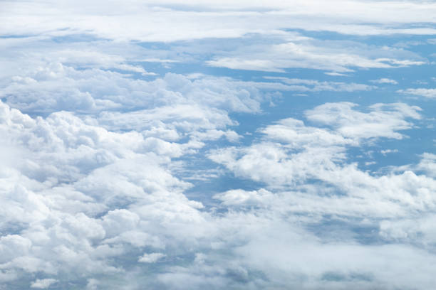 White Clouds on the bright sunny blue sky. Nature background.