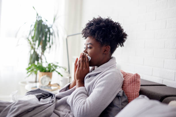istock Woman lying in bed with virus and high temperature 1204115051
