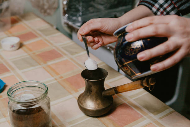 istock Hand pours sugar into cezve for brewing coffee 1204115123
