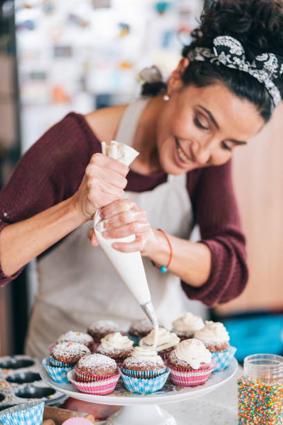 istock Confectioner decorating Chocolate Muffins 1204116626