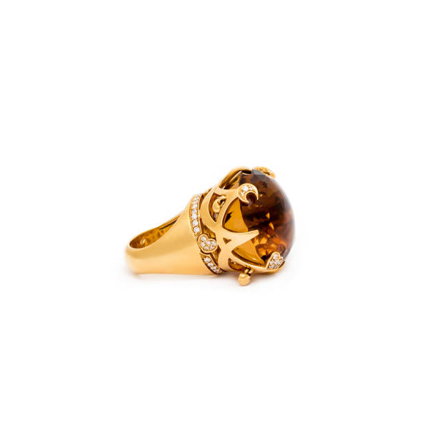 istock Golden diamond ring isolated on white background. Ring with diamonds and precious color gemstones. Luxury jewelry, yellow gold. 1204117575