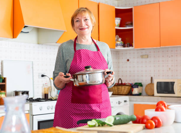 istock Elderly woman at kitchen 1204120419