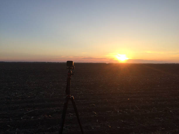 istock A small camera mounted on a tripod shoots sunset sky. 1204120731