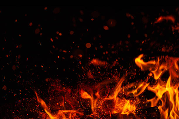 istock Blazing flame and sparks isolated on black background 1204124407