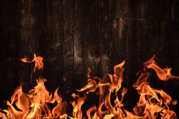 istock Dark wood texture and blazing flame on the foreground 1204124528