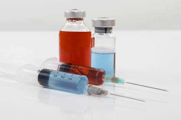 istock Syringe and medicine bottles on white background. 1204125789