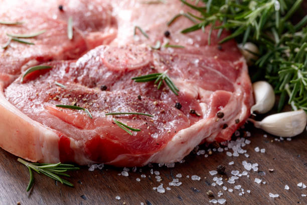 istock Raw pork with rosemary , salt and pepper. 1204126550