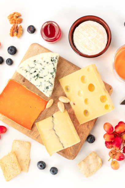 istock Cheese platter, a flat lay top shot on a white background. Blue cheese, Dutch cheese, and others, a variety with fruits and nuts 1204128196